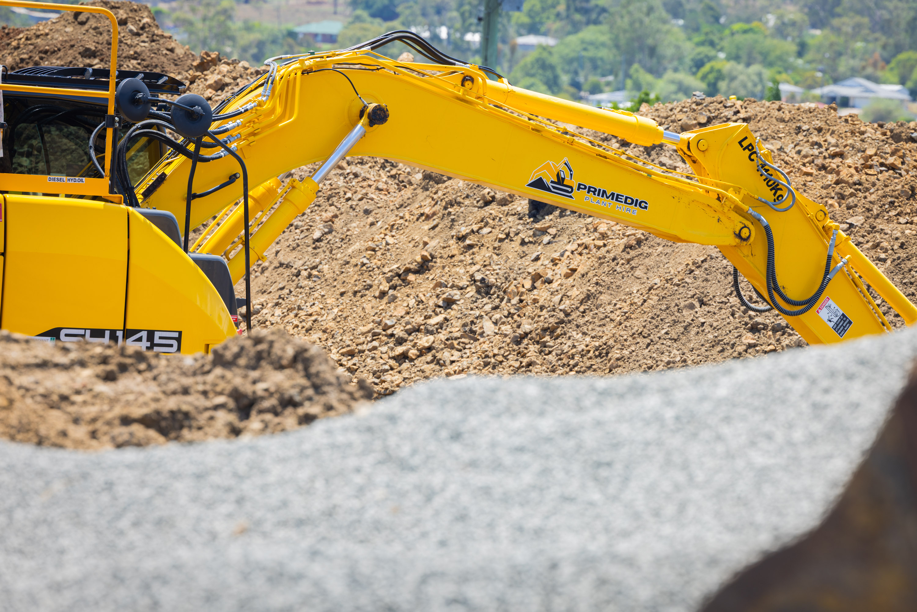 Sumitomo SH145X-7 excavator digging into a dirt bank